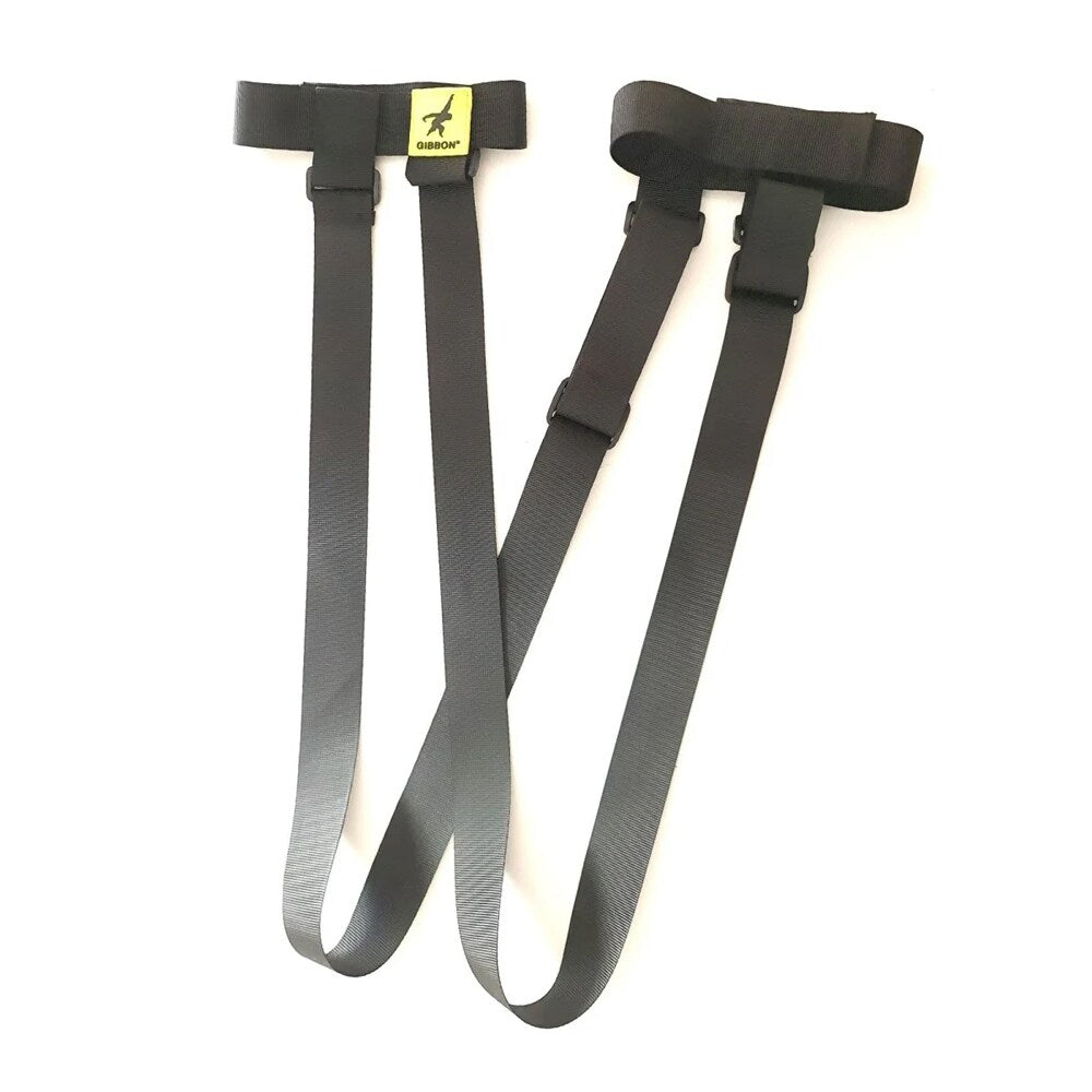Ett par svarta GIBBON Shoulderstraps med justerbara spännen och en gul logotyp, framställda mot en vit bakgrund.