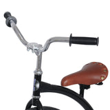 Närbild på Hoppley Penny Farthing 29 tums höghjuling. Visar kromfärgat styre, svarta handtag och en klassisk brun sadel med nitar