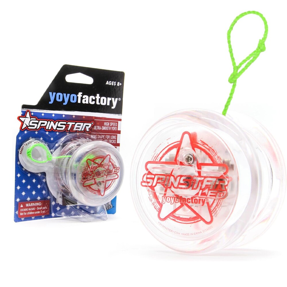 Produktbild på en genomskinlig Spinstar LED jojo från YoyoFactory med röd grafik av en stjärna och texten "Spinstar LED". Jojon har ett neongrönt snöre och står bredvid sin originalförpackning som har ett stjärnmönstrat tema i rött, vitt och blått.